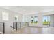 Bright living room with hardwood floors, a black railing, and a view of the outdoors at 11475 E Briarwood Cir, Centennial, CO 80112