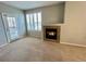 Bright living room featuring shuttered windows, neutral decor, plush carpeting, and a modern fireplace at 17525 Wilde Ave # 207, Parker, CO 80134