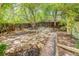 Expansive backyard featuring a stone patio, lush greenery, and ample space for outdoor activities at 2227 N Gilpin St, Denver, CO 80205