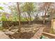 Backyard features stone landscaping, lush trees and bushes providing a peaceful and private atmosphere at 2227 N Gilpin St, Denver, CO 80205