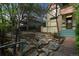 Backyard with stone landscaping, mature trees, and partial fencing offering a peaceful and private setting at 2227 N Gilpin St, Denver, CO 80205
