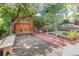 Serene backyard with lush landscaping, a charming table, and garden beds for outdoor relaxation at 2227 N Gilpin St, Denver, CO 80205