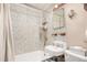 Cozy bathroom showcasing mosaic tile walls, a vintage sink, and a combination tub and shower at 2227 N Gilpin St, Denver, CO 80205