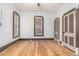 Bright bedroom featuring original hardwood floors, neutral paint, and classic trim throughout at 2227 N Gilpin St, Denver, CO 80205