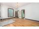 Spacious bedroom with a vintage chandelier, wood floors, and classic trim details at 2227 N Gilpin St, Denver, CO 80205
