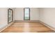Bright bedroom featuring hardwood floors, large windows, and neutral wall tones at 2227 N Gilpin St, Denver, CO 80205
