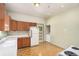 Functional kitchen with classic appliances, wood cabinets, and a light-filled dining area at 2227 N Gilpin St, Denver, CO 80205