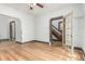 Open-concept living room with hardwood floors, arched entryway, and views of the staircase at 2227 N Gilpin St, Denver, CO 80205