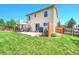Spacious backyard with a large patio, seating area, and well-maintained lawn at 1093 Lilac Cir, Broomfield, CO 80020