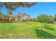 Spacious backyard features a well-maintained lawn, patio with seating, and mature trees, perfect for outdoor activities at 1093 Lilac Cir, Broomfield, CO 80020