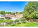 This spacious backyard has mature trees and a view of the mountains at 1093 Lilac Cir, Broomfield, CO 80020