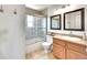 Neutral bathroom with a shower-tub, framed vanity mirror, and modern tile at 1093 Lilac Cir, Broomfield, CO 80020