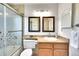 Bright bathroom featuring a shower-tub, framed vanity mirror, and decorative accent at 1093 Lilac Cir, Broomfield, CO 80020
