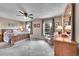 Spacious bedroom with carpet, a ceiling fan, and windows with outside views at 1093 Lilac Cir, Broomfield, CO 80020