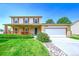 Charming two-story home featuring a spacious front yard, cozy porch, and a two-car garage at 1093 Lilac Cir, Broomfield, CO 80020