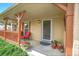 Inviting front porch with comfortable seating, potted plants, and a view of the well-maintained garden at 1093 Lilac Cir, Broomfield, CO 80020