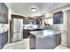 Well lit kitchen featuring stainless steel appliances, granite counters, and brown wood cabinets at 1093 Lilac Cir, Broomfield, CO 80020
