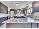Spacious kitchen featuring stainless steel appliances, white tile backsplash, and dark wood cabinetry at 1093 Lilac Cir, Broomfield, CO 80020