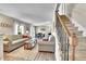 Comfortable living room with wood floors, neutral decor, and staircase, perfect for relaxation and entertaining at 1093 Lilac Cir, Broomfield, CO 80020