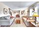 Bright and airy living room with wood floors, neutral sofas, and large windows offering plenty of natural light at 1093 Lilac Cir, Broomfield, CO 80020