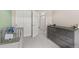 Bedroom features a gray crib, dresser, and closet, offering ample storage at 193 Ambrose St, Erie, CO 80516