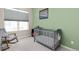 Charming Bedroom showcases a gray crib, rocking chair, and window at 193 Ambrose St, Erie, CO 80516
