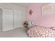 A playful bedroom featuring a bed, toy kitchen set, and pastel pink accents for a cheerful space at 193 Ambrose St, Erie, CO 80516