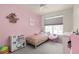 Bright bedroom featuring a pink wall, a cute Hello Kitty chair, and a playful, -friendly aesthetic at 193 Ambrose St, Erie, CO 80516