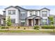 Townhome featuring a covered porch, landscaped front yard and neutral-toned exterior at 193 Ambrose St, Erie, CO 80516