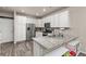 Bright kitchen featuring white cabinets, stainless steel appliances, and a breakfast bar at 193 Ambrose St, Erie, CO 80516
