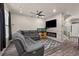 Cozy living room with a fireplace, a large gray couch, and ceiling fan at 193 Ambrose St, Erie, CO 80516