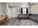 Spacious living room with a dining table, large L-shaped couch, and wood floors at 193 Ambrose St, Erie, CO 80516