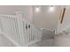 Upstairs staircase features gray carpet steps and a white railing leading downwards at 193 Ambrose St, Erie, CO 80516
