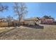 View of backyard with playset, fence, storage shed and gravel under a bright blue sky at 101 2Nd St, Fort Lupton, CO 80621