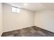 Finished basement room with neutral carpeting, a window, and a light fixture at 101 2Nd St, Fort Lupton, CO 80621