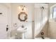 Bathroom with a pedestal sink, a mirror, a shower, and decorative lighting at 101 2Nd St, Fort Lupton, CO 80621