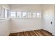 Bedroom featuring hardwood floors, a window, a door and white paint at 101 2Nd St, Fort Lupton, CO 80621