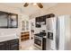 Well-equipped kitchen featuring stainless steel appliances, cabinetry, tile floors, and a ceiling fan at 101 2Nd St, Fort Lupton, CO 80621