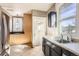 Bright kitchen with stainless steel refrigerator, tile floors, sink, and wood cabinets at 101 2Nd St, Fort Lupton, CO 80621