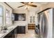 Functional kitchen featuring stainless steel appliances, classic cabinetry, and tile floors at 101 2Nd St, Fort Lupton, CO 80621