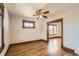 Bright room with hardwood floors, vintage details, ceiling fan, and natural light at 101 2Nd St, Fort Lupton, CO 80621