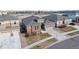 Aerial view of a well-maintained home with a stone exterior, landscaped yard, and paved driveway at 7408 Xenophon St, Arvada, CO 80005