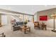 Finished basement featuring a cozy seating area, staircase, and neutral carpeting at 7408 Xenophon St, Arvada, CO 80005