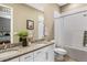 Well-appointed bathroom with double sinks, granite countertops, and a tub with shower at 7408 Xenophon St, Arvada, CO 80005