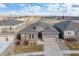 Beautiful single-Gathering home with a two-car garage, stone accents, and well-manicured lawn at 7408 Xenophon St, Arvada, CO 80005