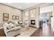 Cozy living room featuring a fireplace, hardwood floors, and neutral paint colors at 7408 Xenophon St, Arvada, CO 80005