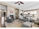 Open concept living room with fireplace flows into bright kitchen, great for entertaining at 7408 Xenophon St, Arvada, CO 80005