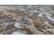 Breathtaking aerial view of a luxurious home surrounded by beautiful hills and sparse vegetation at 3520 Castle Butte Dr, Castle Rock, CO 80109
