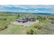 Stunning aerial view of an estate home with professional landscaping, circular driveway, and mountain views at 3520 Castle Butte Dr, Castle Rock, CO 80109