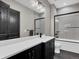 Bathroom with modern fixtures, featuring a white countertop, dark cabinets, and shower with glass door at 3520 Castle Butte Dr, Castle Rock, CO 80109